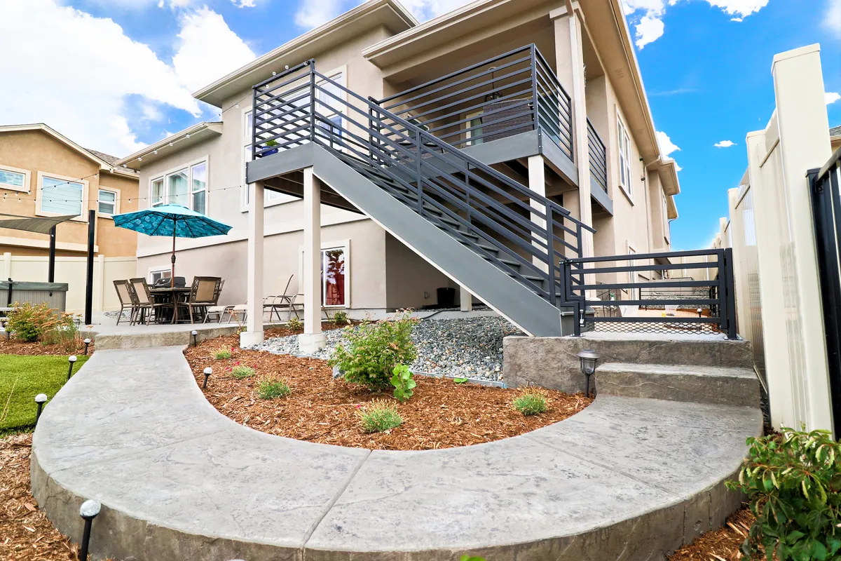 The finished deck, steel stair and stamped-concrete patio