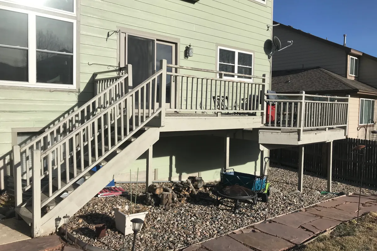 A deck and railing before the rebuild