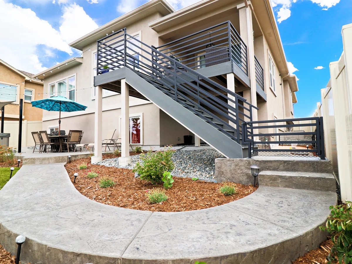 A raised deck and stair run wrapped in Modern horizontal matte-black steel railing
