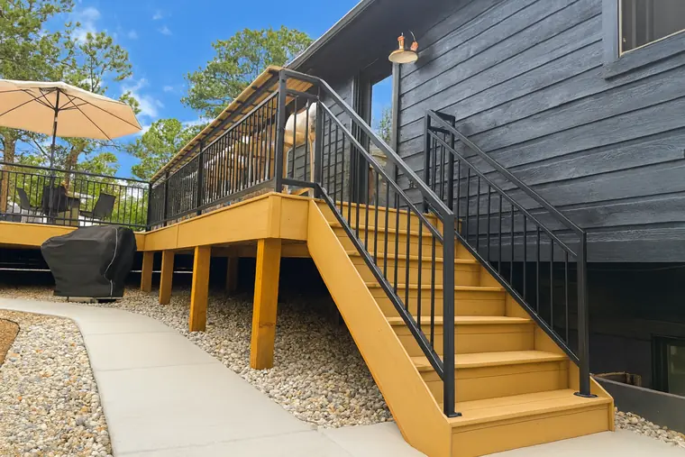The Collins railing following a stair run down to a gravel path
