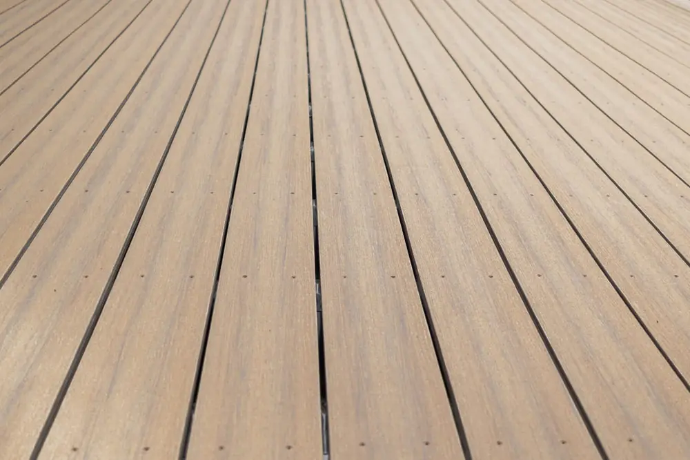 Composite deck boards fastened with color-matched face screws