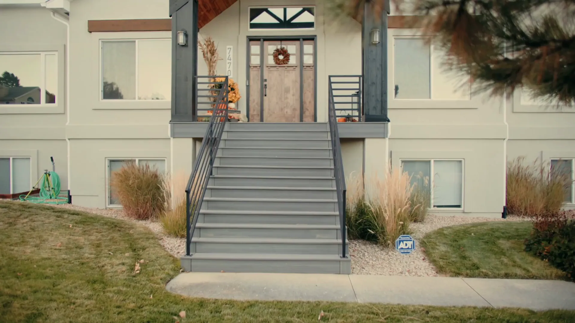 A Stoddard deck and railing running the full width of the house