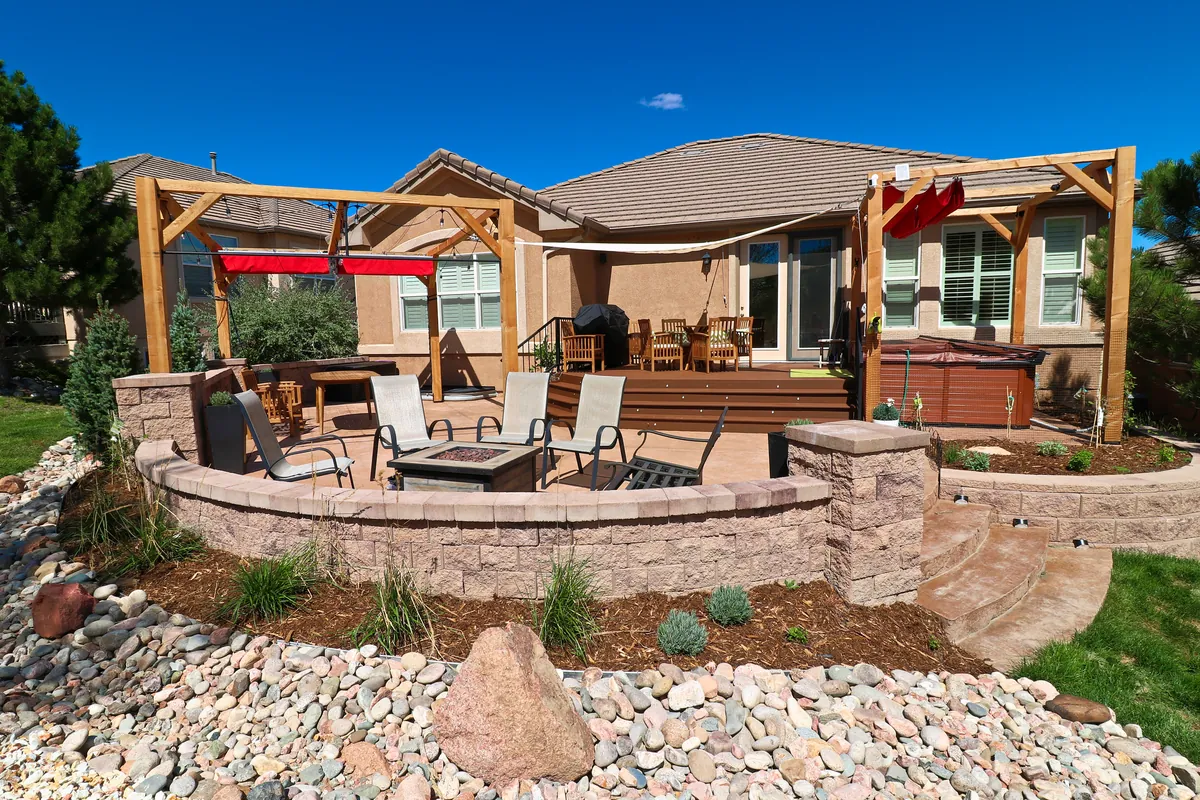 The finished deck, cedar pergola, fire pit and stone patio