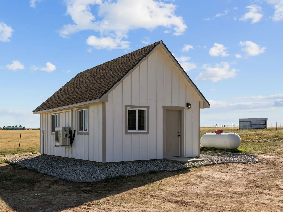 A finished tiny home with board-and-batten siding on the plains in Elbert